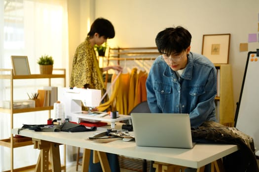 Fashion entrepreneurs working on a new clothing project in a stylish studio.