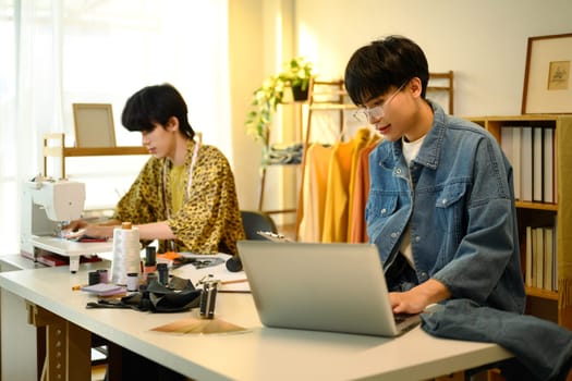 Fashion entrepreneurs working on a new clothing project in a stylish studio.