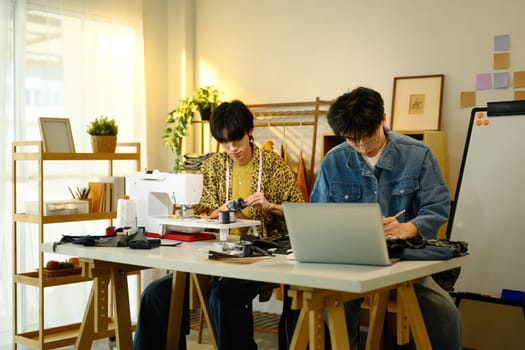 Young designers developing new fashion concepts in a stylish studio.