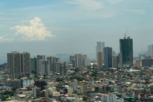 Skyscrapers and business centers in a big city Manila. Urban aerial landscape. Modern metropolis in Asia, top view.