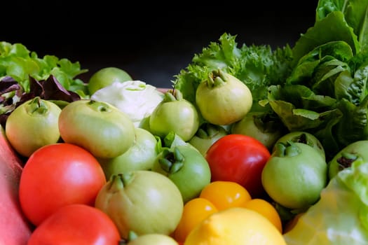 Vegetables in a basket on a dark background. Healthy food.