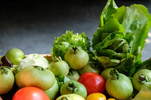 Vegetables in a basket on a dark background. Healthy food.