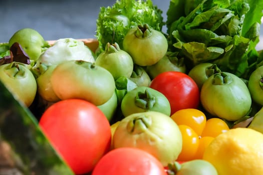 Variety of fresh vegetables in a wooden box. Selective focus.