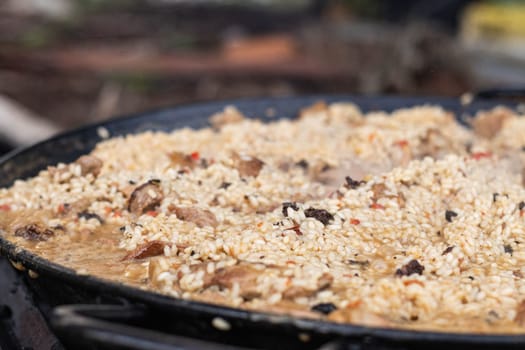 A close-up shot captures a flavorful rice dish, rich with tender meat and spices, evoking cravings and a sense of community around shared meals.