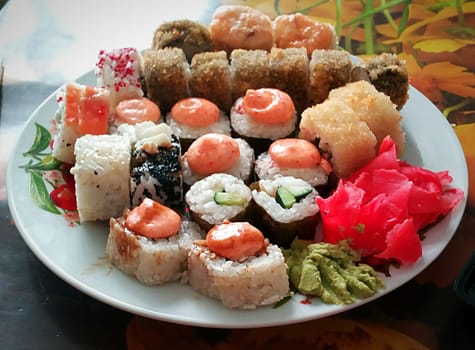 Sushi and rolls on a plate, seafood set, Southeast Asian cuisine.