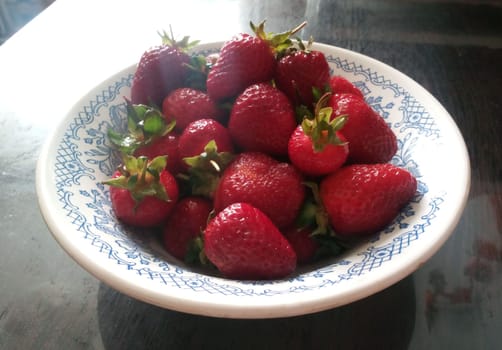 Freshly picked and full of flavour, these strawberries are a delightful addition to any table. Their vibrant red hue is not only pleasing to the eye, but also symbolises the rich nutrients they provide.