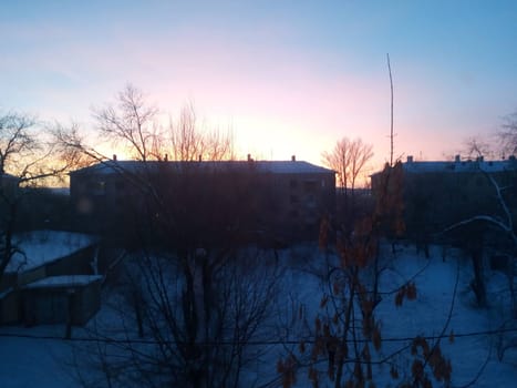 When the sun goes down, the city turns into a winter wonderland. Snow covers the streets and the rooftops rise against a sky filled with twilight hues.