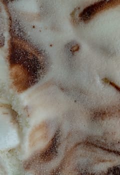 Top view of Surface texture delicious creamy chunky vanilla ice cream. Details of rich vanilla ice cream with crunchy cashew nuts and chocolate chips, use it as your Wallpaper, Poster and Copy space, Selective focus.