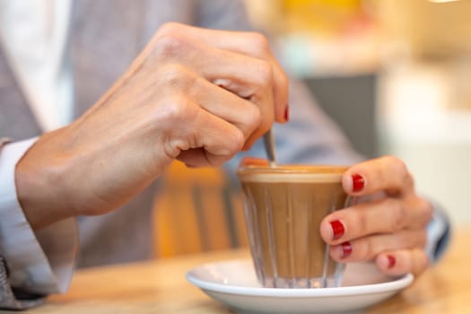 Business woman in a trendy cafe drinking coffee. Beautiful caucasian. .indoors