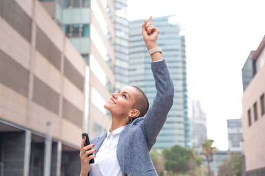 Middle adult female, caucasian female, pointing with thumbs up. Happy facial expression.