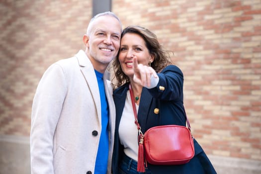 Young traveling couple with bags, look for information about hotels, shopping centers and transportation guides. lifestyle and travel concept.