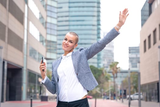 Middle adult female, caucasian female, pointing with thumbs up. Happy facial expression.