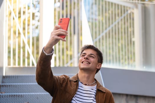 Happy guy making a video call with a smartphone.