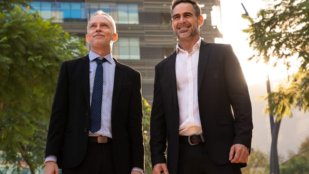 Portrait Of Two Trusted Business Colleagues Dressed In Formal Suit Walking Together Outside Work Center During Work Meeting.