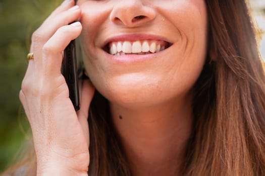 Portrait Happy young Woman With Perfect White Teeth Smiling On telephone.