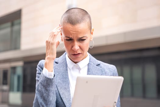 Thoughtful businesswoman with results of businesswoman walking down the street outside office building, a mature boss holds a phone in her hands, writes messages and reads news online, using an app.