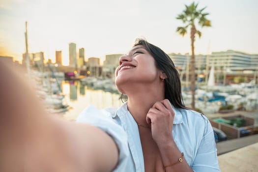 Happy female making a self-portrait with a smartphone.