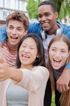 group of friends taking a selfie together and laughing together at the university.Technology or networking, connectivity and happy college people take a photo smiling for social media