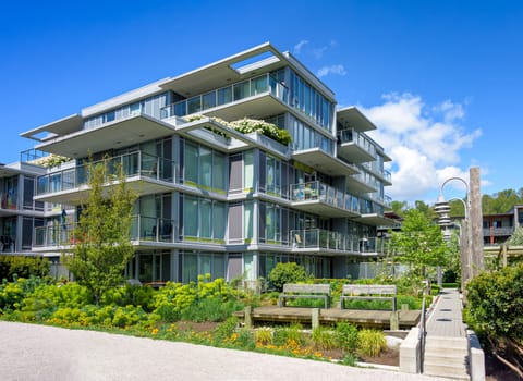 A perfect neighborhood. Pathway in residential park between the buildings on bright sunny day