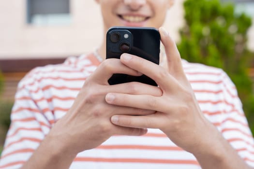 man hands typing on phone browsing mobile phone on social media