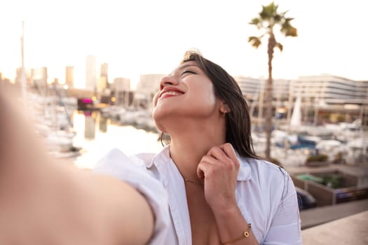 Happy female making a self-portrait with a smartphone.