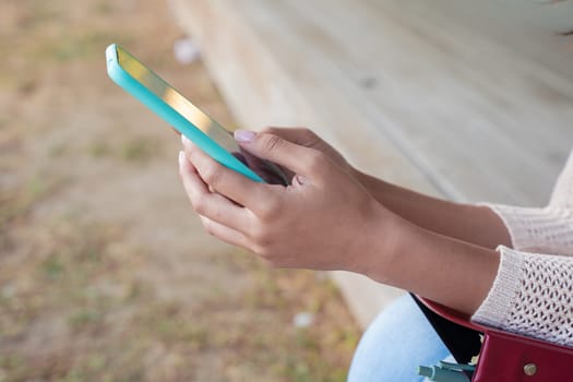 Woman hands typing on phone browsing mobile phone on social media