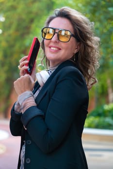 Beautiful average adult caucasian woman wearing glasses having a cell phone conversation.