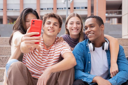 Happy multiethnic group of young friends take a selfie together on campus. multiracial students gathering in the city, concepts of youth, people lifestyle, diversity, teenage and urban life