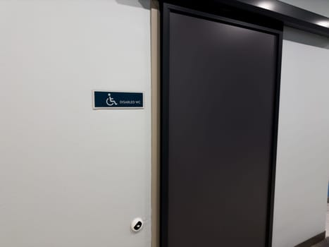Entrance to toilet with sliding door for wheelchair users. Special toilet in public place for people with disabilities. Creating comfortable areas for people with mobility problems