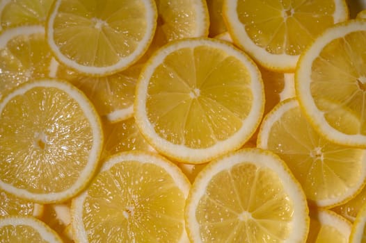 Freshly cut lemon slices showcase their zesty texture, inviting taste and color in a warm, sunlit setting.