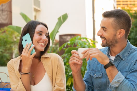 Happy woman talking on cell phone. a girl smiling using a mobile phone. Bride and groom on the terrace of a cafe