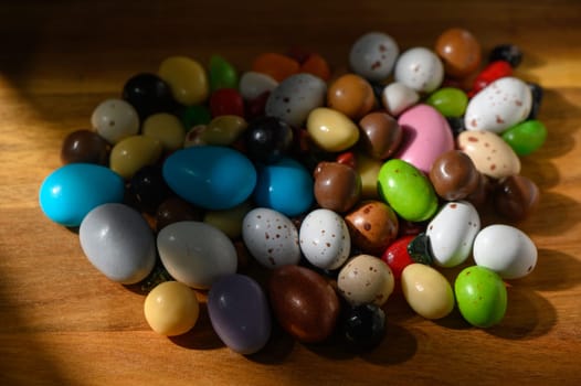 A vibrant collection of decorative eggs lies on a wooden surface, illuminated by soft spring sunlight.