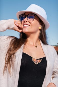 Young caucasian woman smiling at the sky with glasses outdoors. Front view of a young lawyer with positive expression staring
