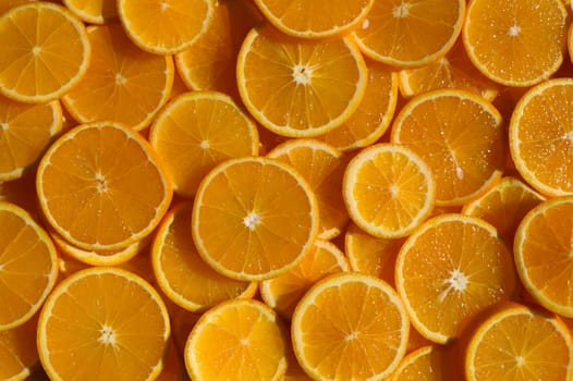 Juicy orange slices lie side by side, creating a burst of color and freshness perfect for a summer gathering.