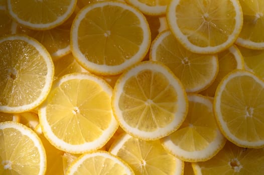Bright yellow lemon slices lie neatly together, ready to add zest and freshness to dishes or beverages.