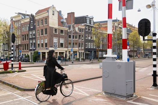 AMSTERDAM, THE NETHERLANDS - APRIL 16, 2019: The Cyclists on bicycles wait for a green traffic light