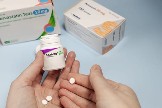 Female hands holding Oxabenz sedative pills. Prescription medication. Copenhagen, Denmark - February 11, 2025