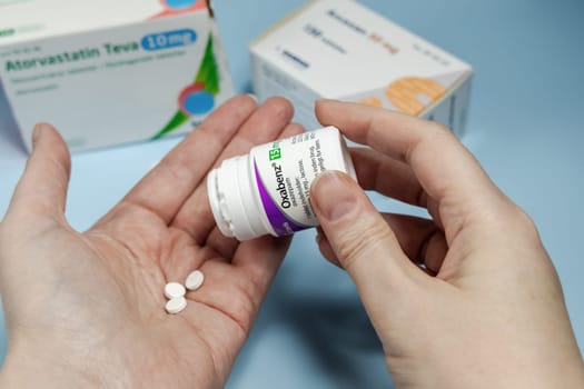 Female hands holding Oxabenz sedative pills. Prescription medication. Copenhagen, Denmark - February 11, 2025