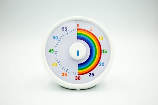 Colorful circular kids timer with rainbow sections and white frame.