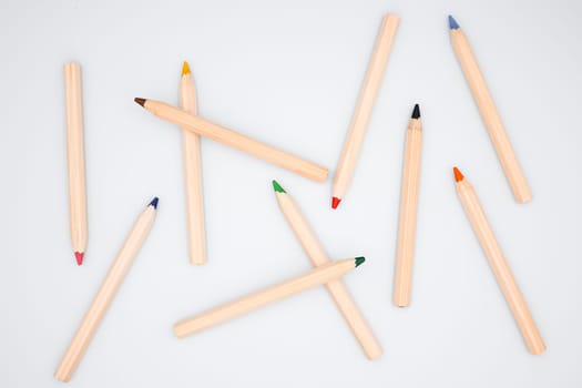 Assorted colored pencils on white background. Creative art supplies display.