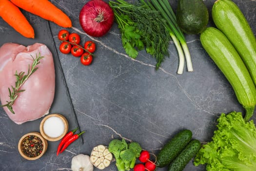 Raw turkey fillet with a sprig of rosemary, spices in wooden bowls, vegetables, root vegetables and herbs on a dark background with space for text. The concept of proper and healthy nutrition, diet, menu, natural and organic products. High quality photo