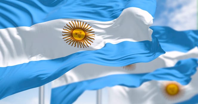 Argentina national flags waving on a clear day. Three equal blue and white horizontal bands with the Sun of May in the center. 3d illustration render. Close-up. Pride and patriotism