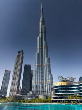 UAE, Dubai, 10 December 2024: The famous Burj Khalifa skyscraper at sunny day, Dubai's sights during the incredible blue sky. High quality photo