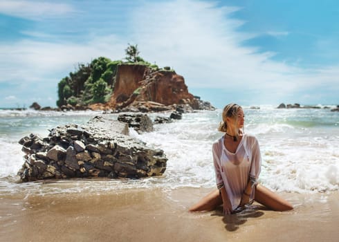 Beautiful young woman in sexy bikini standing at sea beach. High quality photo