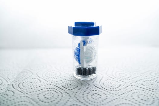 close-up of a container for cleaning and storing contact lenses for the eyes, used at home. For soft and hard lenses. in the container there is an active cleaning process, bubbles are released