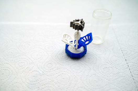 container for cleaning and storing contact lenses for eyes, used at home. For soft and hard lenses. the container consists of two parts, the first part for lenses, open, the second part for liquid.