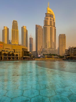 UAE, Dubai, 26 September 2024: The famous shopping center Dubai Mall and Burj Khalifa skyscraper at dusk, Dubai's sights and skyscrapers illuminated at night, palm trees. High quality photo