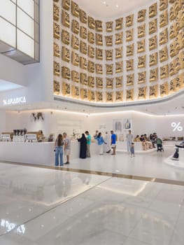 UAE, Dubai, 24 September 2024: the interiors of the largest shopping mall in the world, Dubai Mall, the storefronts of branded stores and visitors to the famous mall. High quality photo