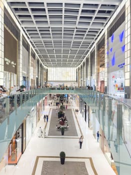UAE, Dubai, 24 September 2024: the interiors of the largest shopping mall in the world, Dubai Mall, the storefronts of branded stores and visitors to the famous mall. High quality photo