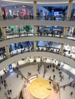 UAE, Dubai, 26 September 2024: the interiors of the largest shopping mall in the world, Dubai Mall, the storefronts of branded stores and visitors to the famous mall. High quality photo